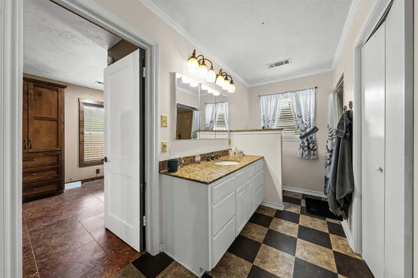 a bathroom with a sink a vanity and a mirror