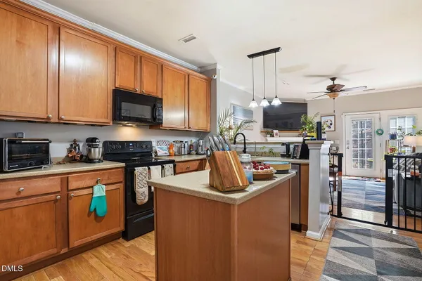 a kitchen with stainless steel appliances granite countertop a stove top oven a sink dishwasher a refrigerator and a microwave