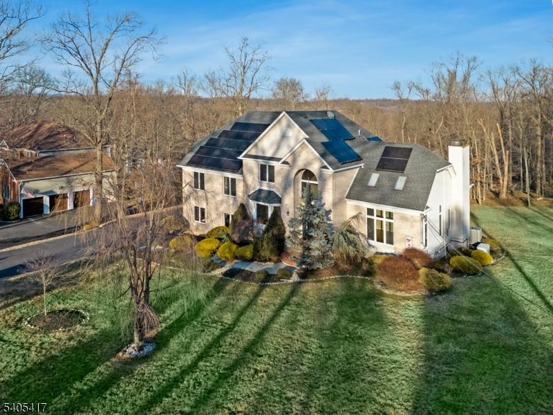 an aerial view of a house with a big yard