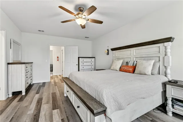 a spacious bedroom with a bed and a chandelier