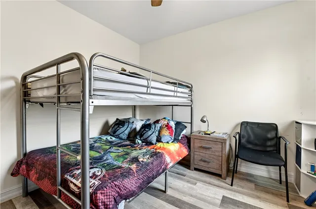 a bed room with a bed and a chair