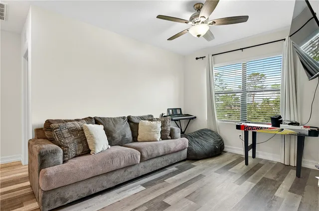 a living room with furniture and a large window