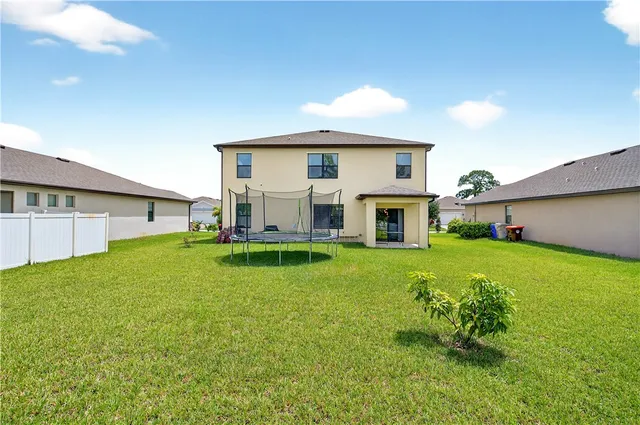 a view of a house with a back yard