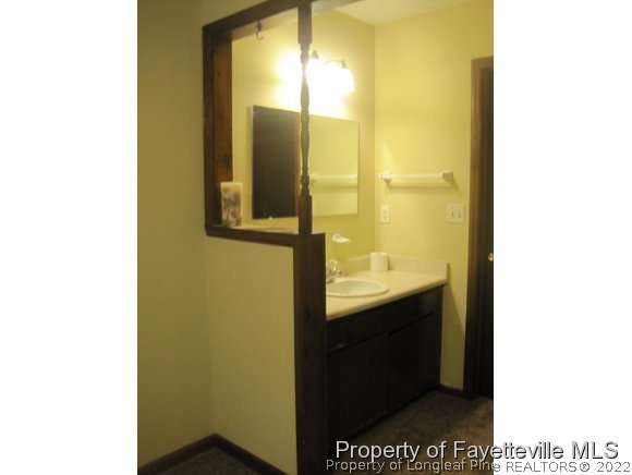1686 Rim Road Fayetteville, NC 28314 - Photo 7 of 12 a bathroom with a sink and a mirror