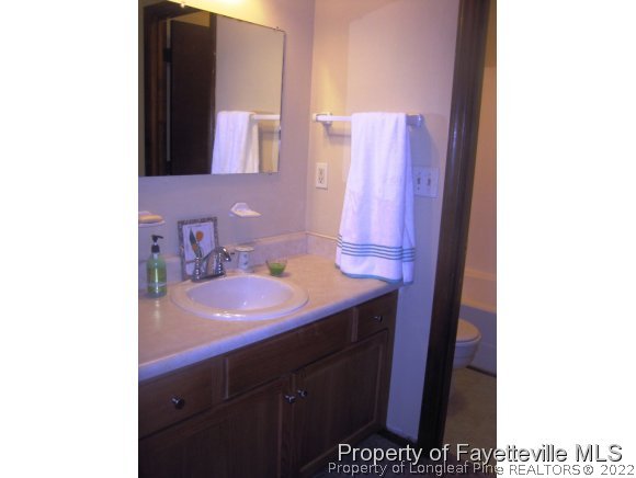 1686 Rim Road Fayetteville, NC 28314 - Photo 8 of 12 a bathroom with a sink and a mirror