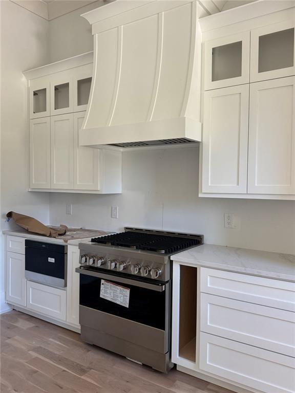 3425 Thompson Mill Road Buford, GA 30519 - Photo 32 of 48 a kitchen with granite countertop white cabinets and stainless steel appliances