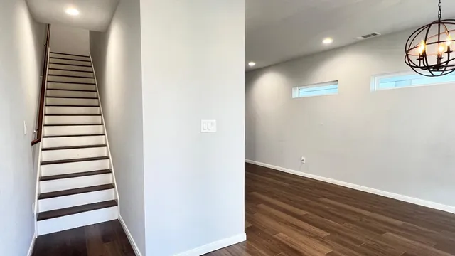 a view of a room with wooden floor