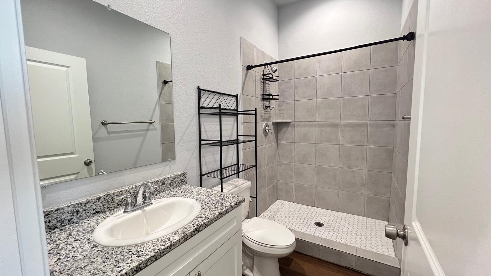 4922 Dalhart Dr Spring Spring, TX 77379 - Photo 26 of 33 a bathroom with a granite countertop sink toilet and shower