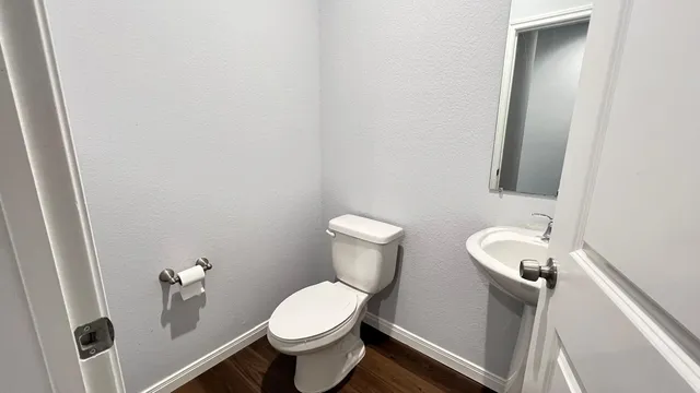 a white toilet sitting next to a bathroom sink