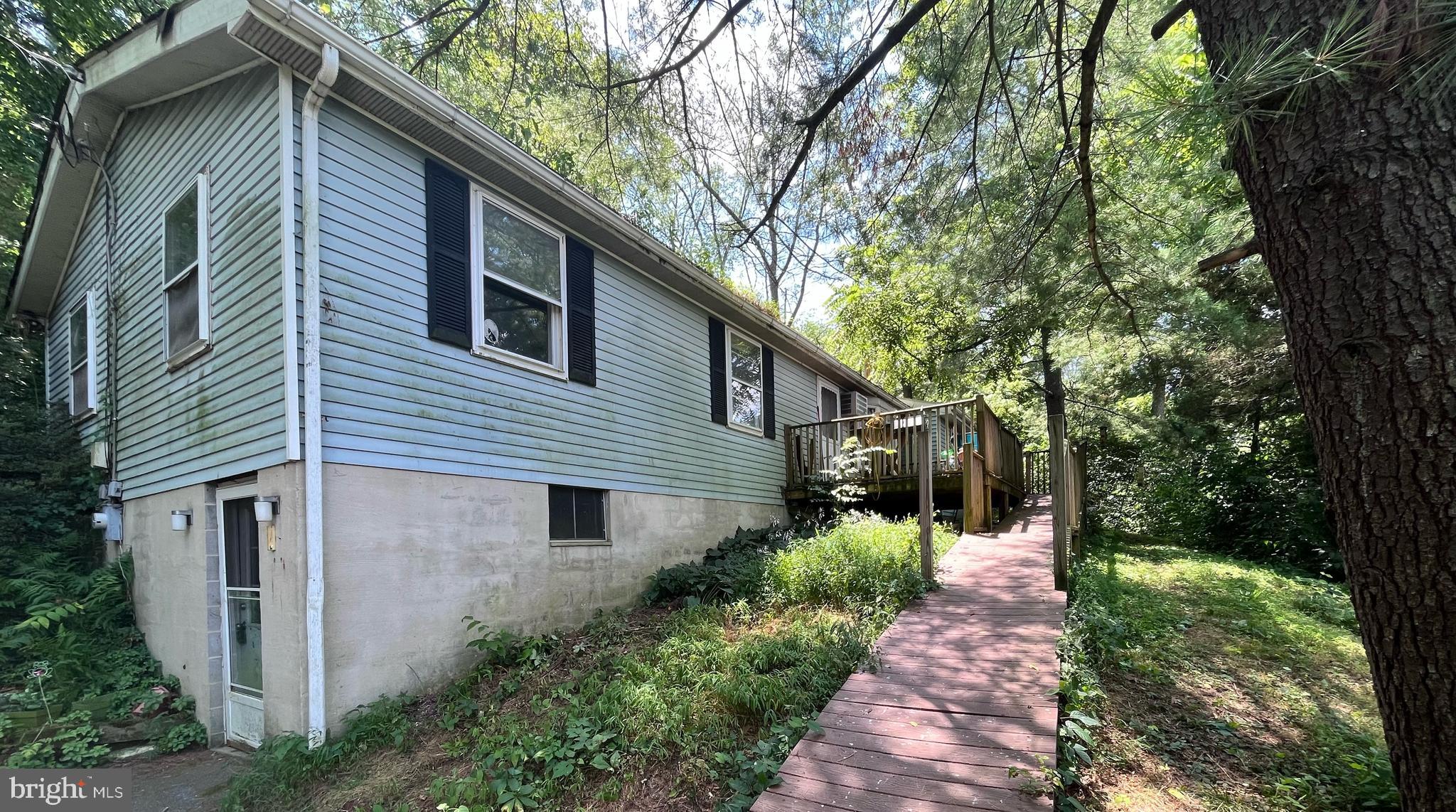 a front view of a house with a yard and trees