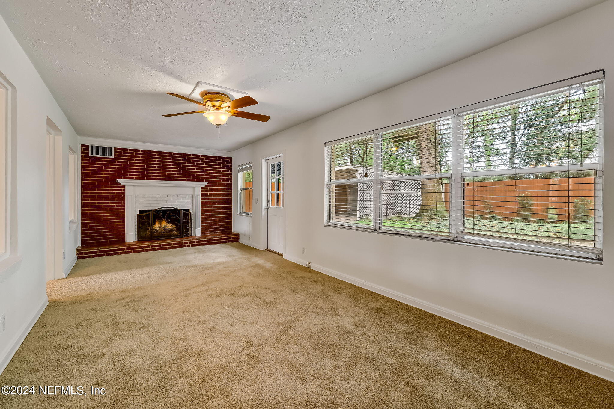 5614 Capri Road Jacksonville, FL 32244 - Photo 18 of 45 a living room with furniture and a fireplace