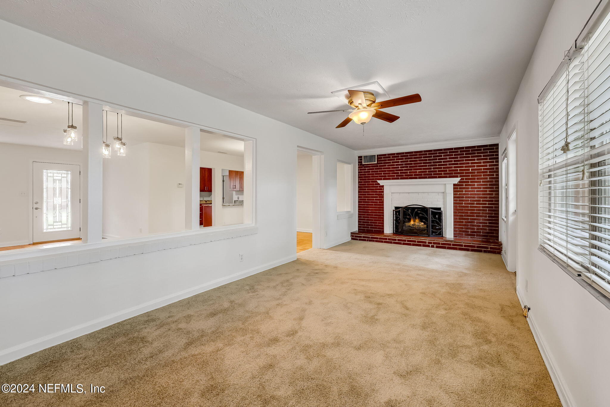 5614 Capri Road Jacksonville, FL 32244 - Photo 19 of 45 a living room with furniture and a fireplace