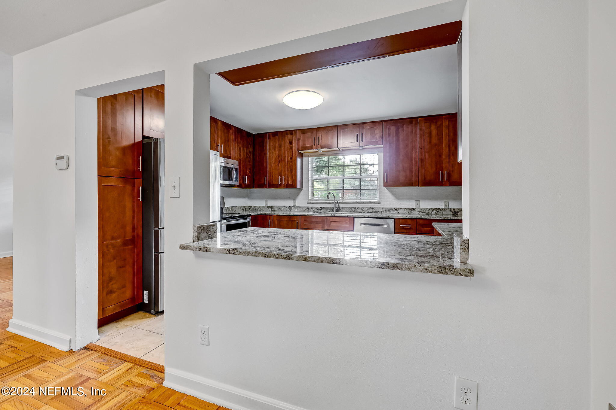 5614 Capri Road Jacksonville, FL 32244 - Photo 21 of 45 a kitchen with stainless steel appliances granite countertop a refrigerator and a sink