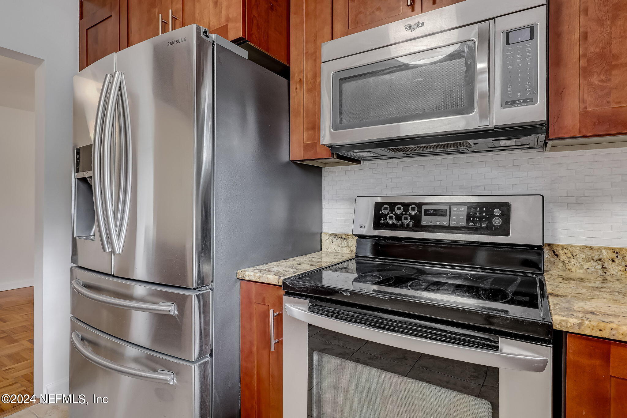 5614 Capri Road Jacksonville, FL 32244 - Photo 23 of 45 a kitchen with stainless steel appliances granite countertop a stove microwave and refrigerator
