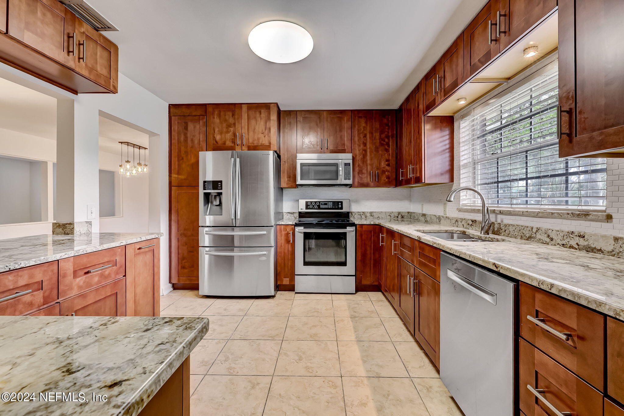 5614 Capri Road Jacksonville, FL 32244 - Photo 25 of 45 a kitchen with stainless steel appliances granite countertop a stove top oven a sink and dishwasher