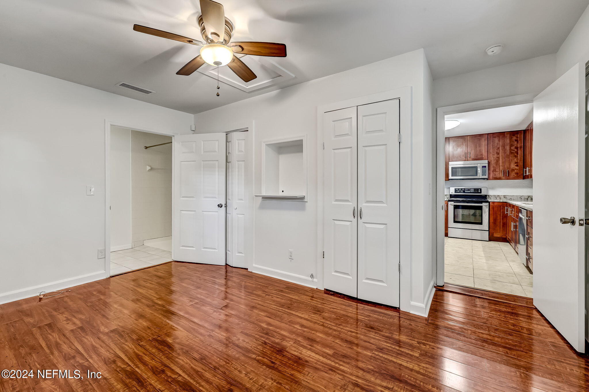 5614 Capri Road Jacksonville, FL 32244 - Photo 26 of 45 a view of empty room with wooden floor and ceiling fan