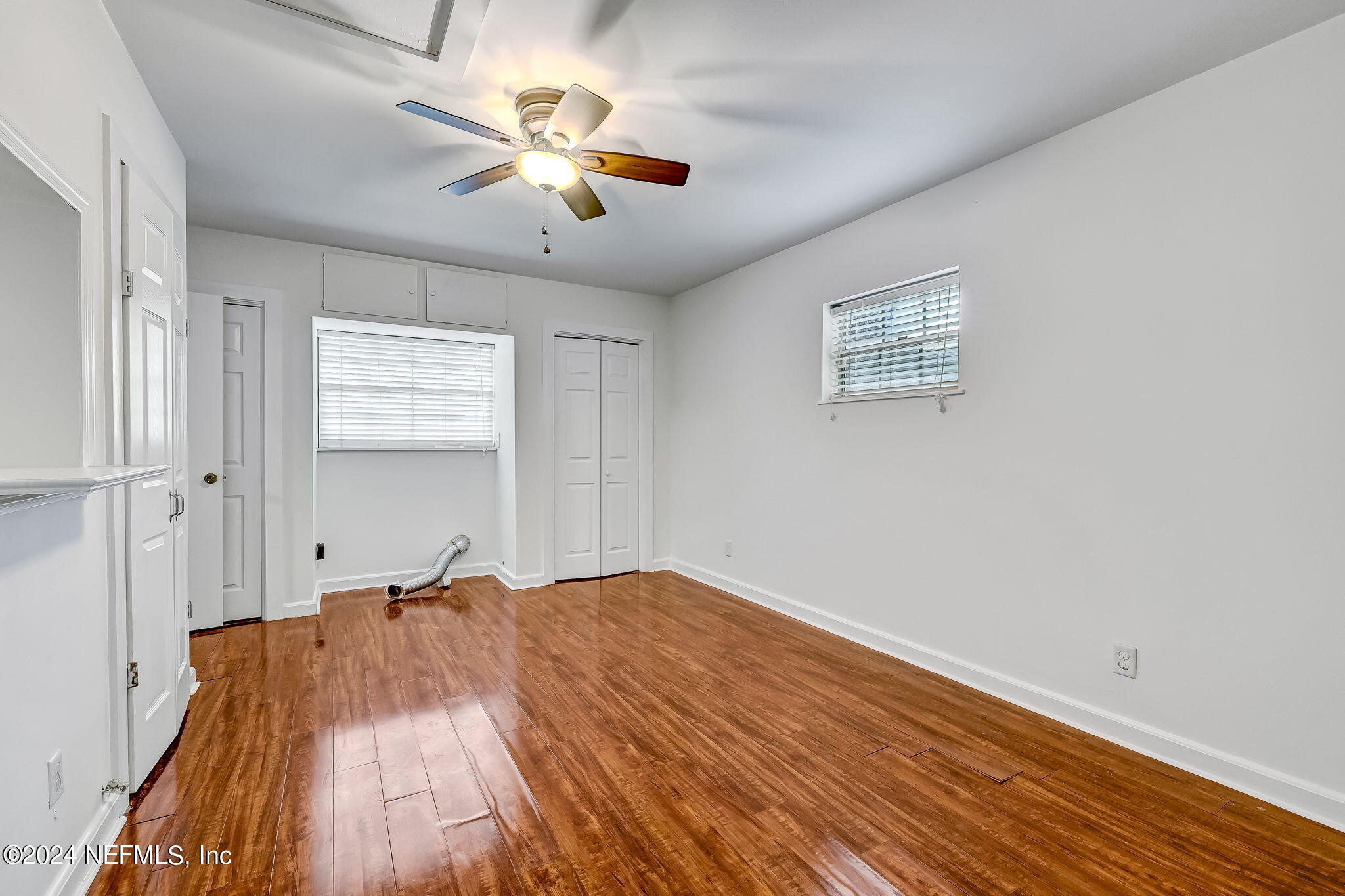 5614 Capri Road Jacksonville, FL 32244 - Photo 28 of 45 an empty room with wooden floor and windows