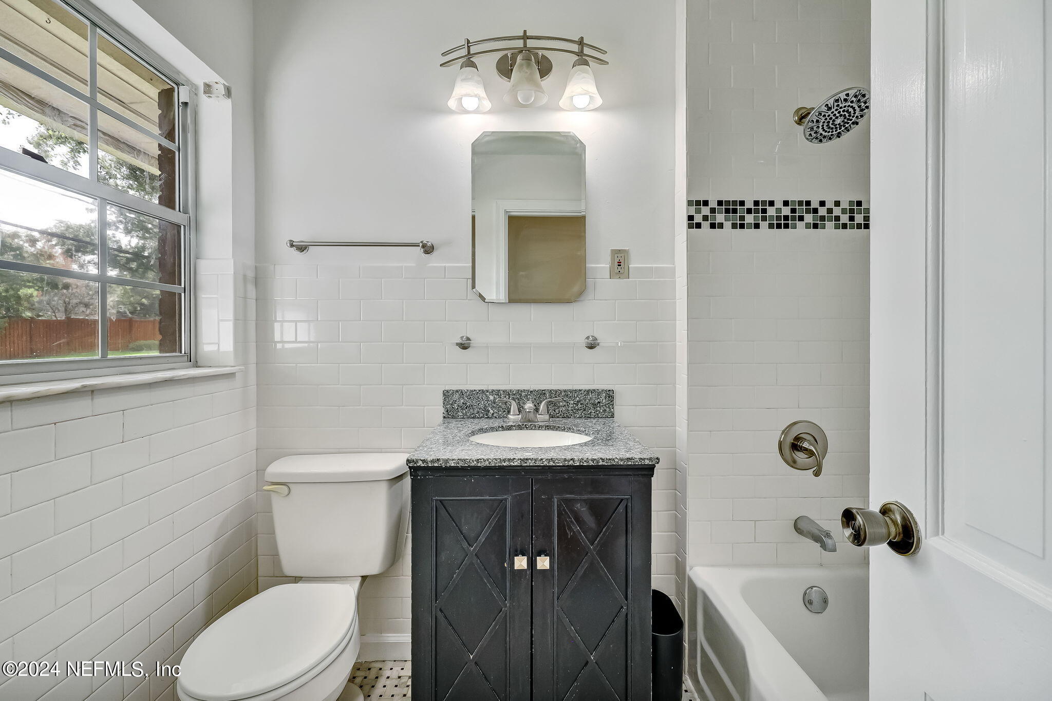 5614 Capri Road Jacksonville, FL 32244 - Photo 33 of 45 a bathroom with a toilet a sink and mirror