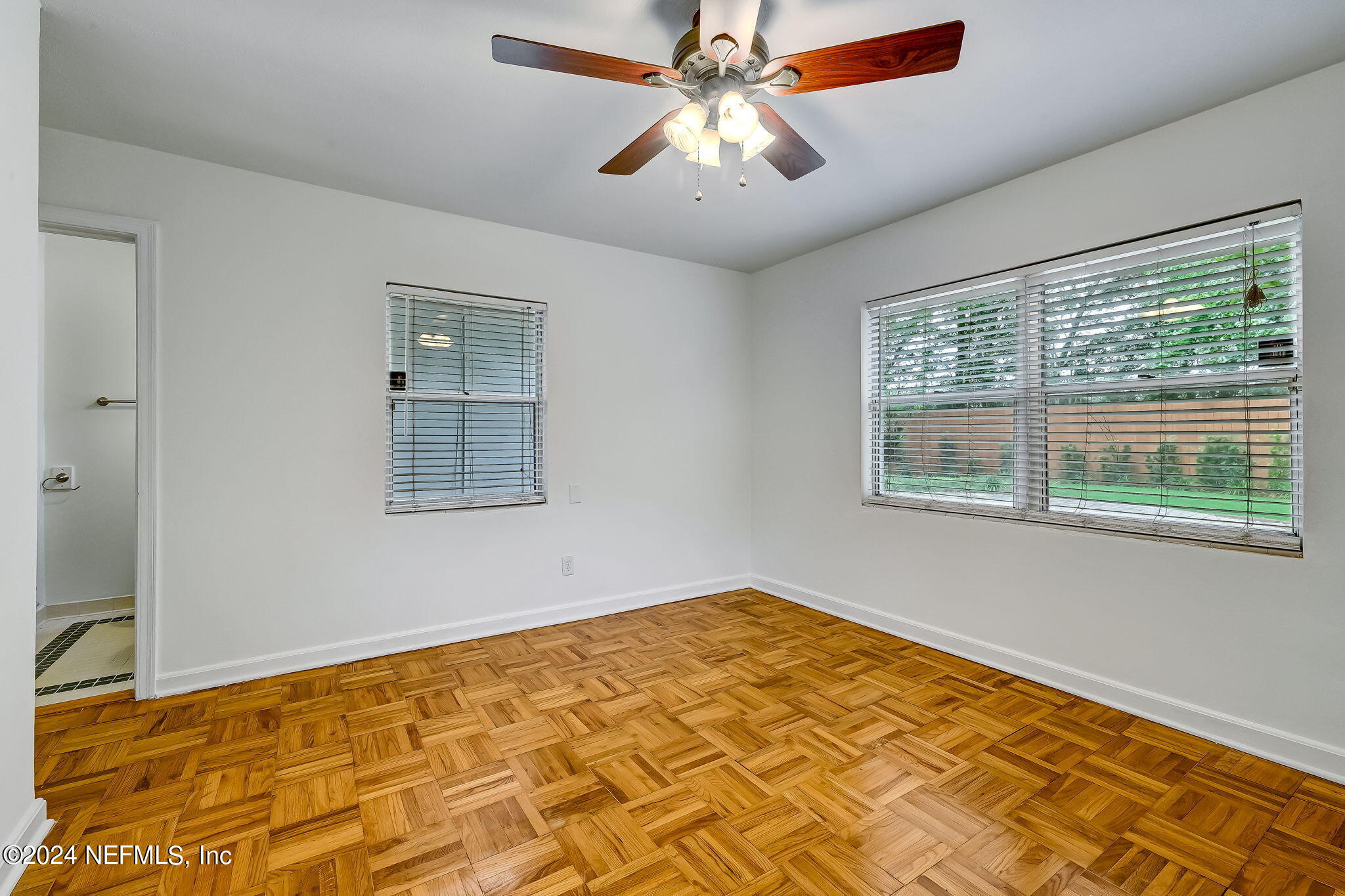 5614 Capri Road Jacksonville, FL 32244 - Photo 38 of 45 a view of a room with wooden floor and chandelier fan