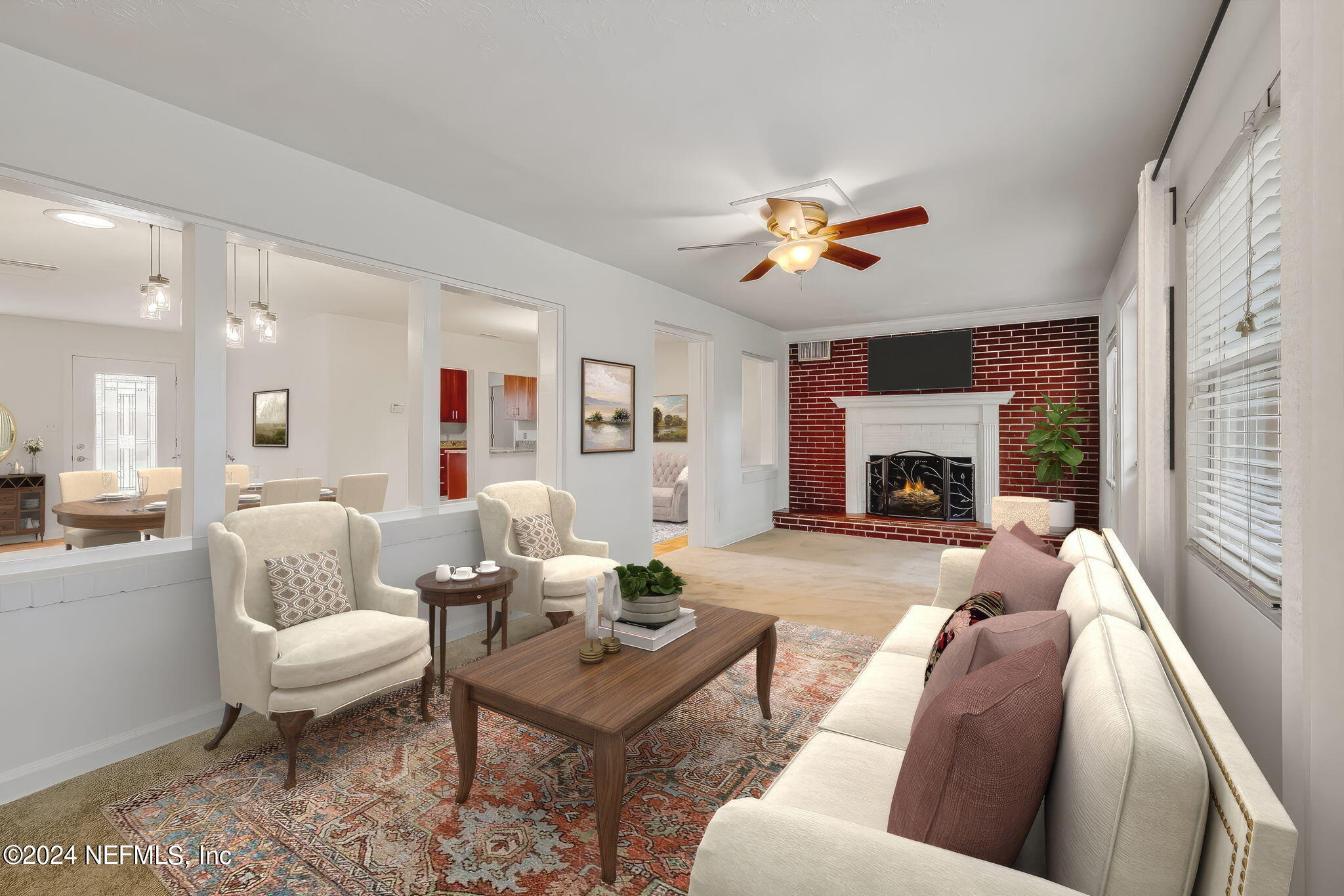 5614 Capri Road Jacksonville, FL 32244 - Photo 4 of 45 a living room with furniture a fireplace and a potted plant