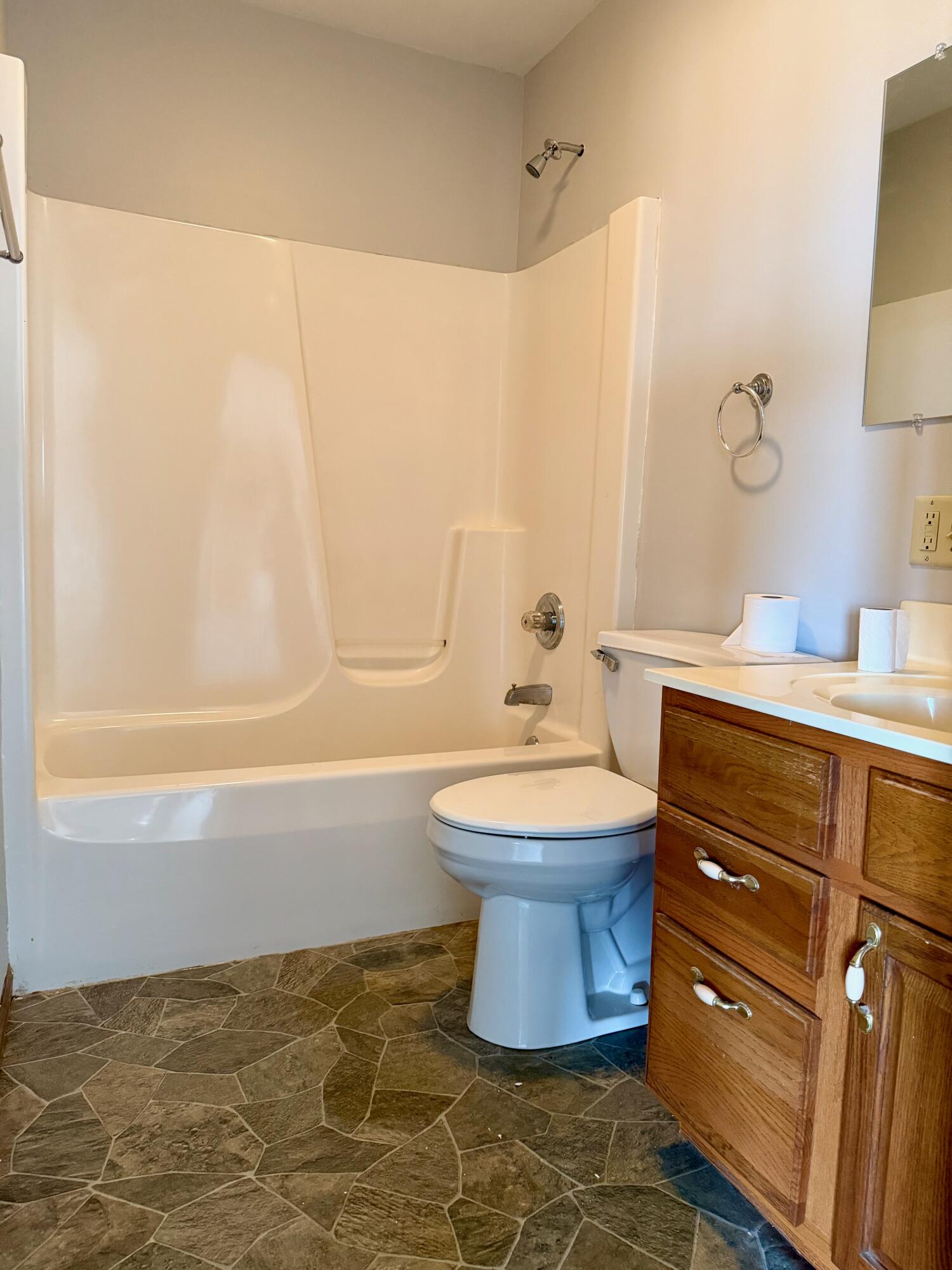5831 West 700 North Winamac, IN 46996 - Photo 14 of 22 a bathroom with a toilet sink and mirror