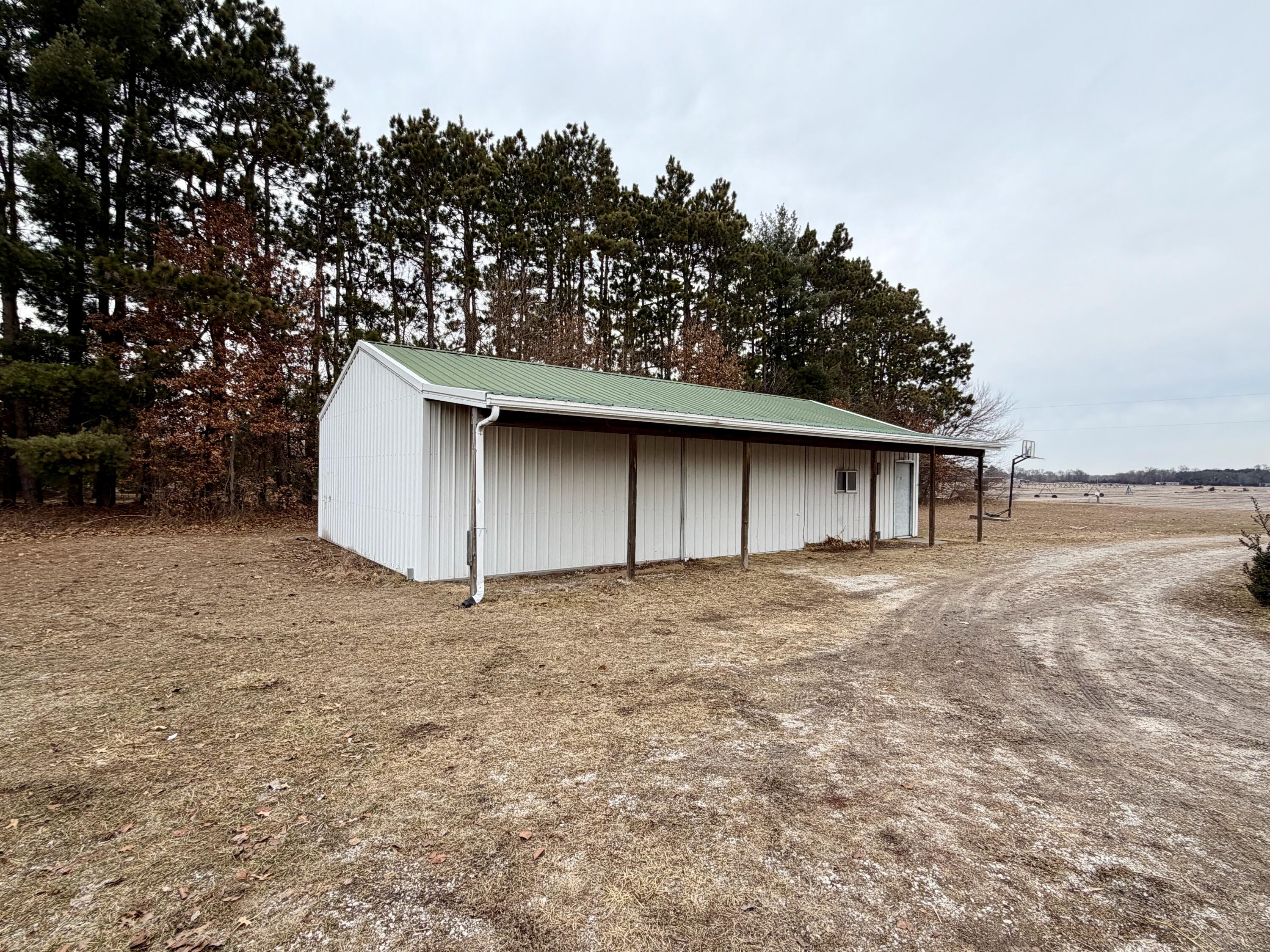 5831 West 700 North Winamac, IN 46996 - Photo 17 of 22 a house with trees in the background