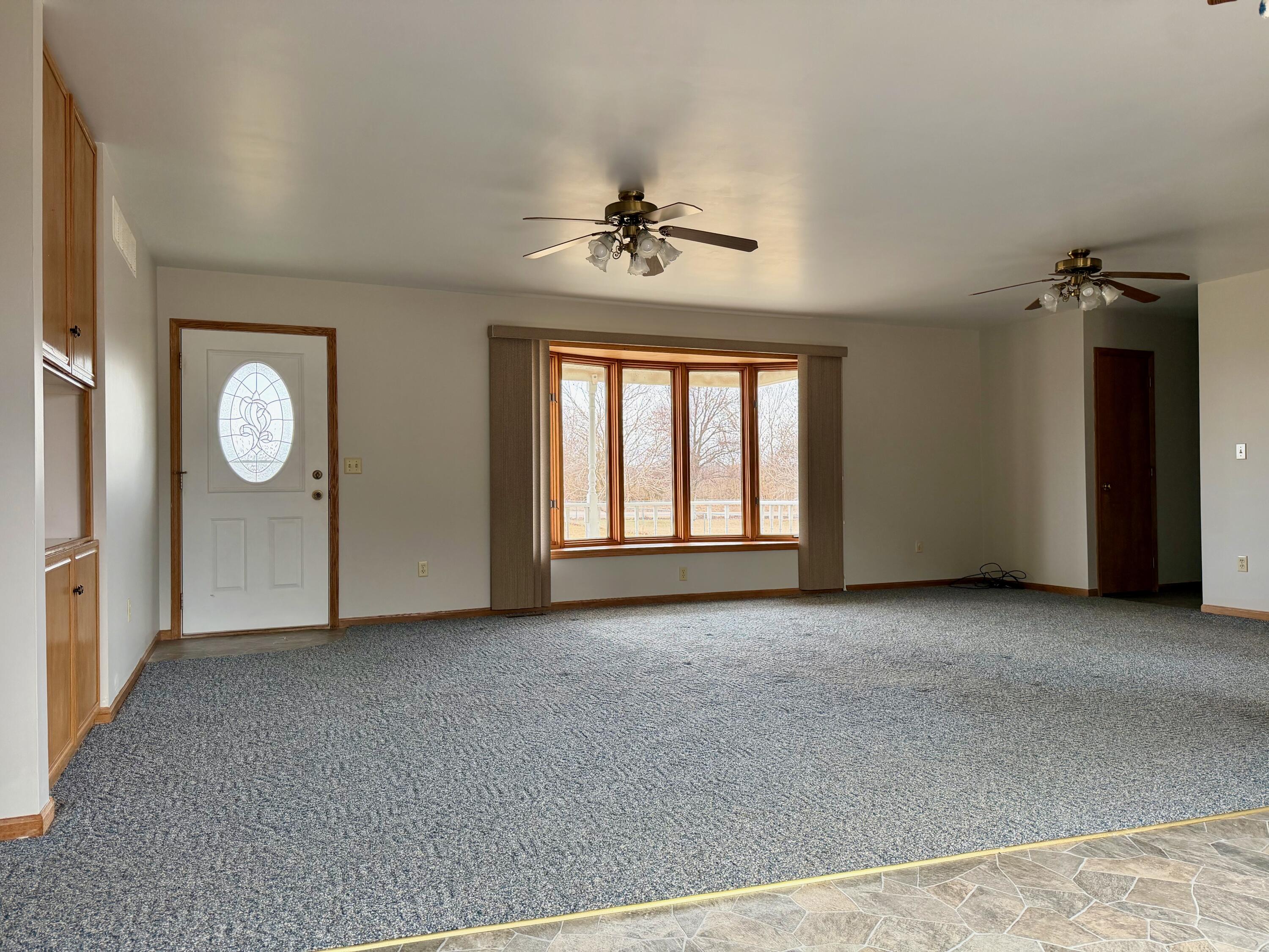 5831 West 700 North Winamac, IN 46996 - Photo 2 of 22 an empty room with windows and fan