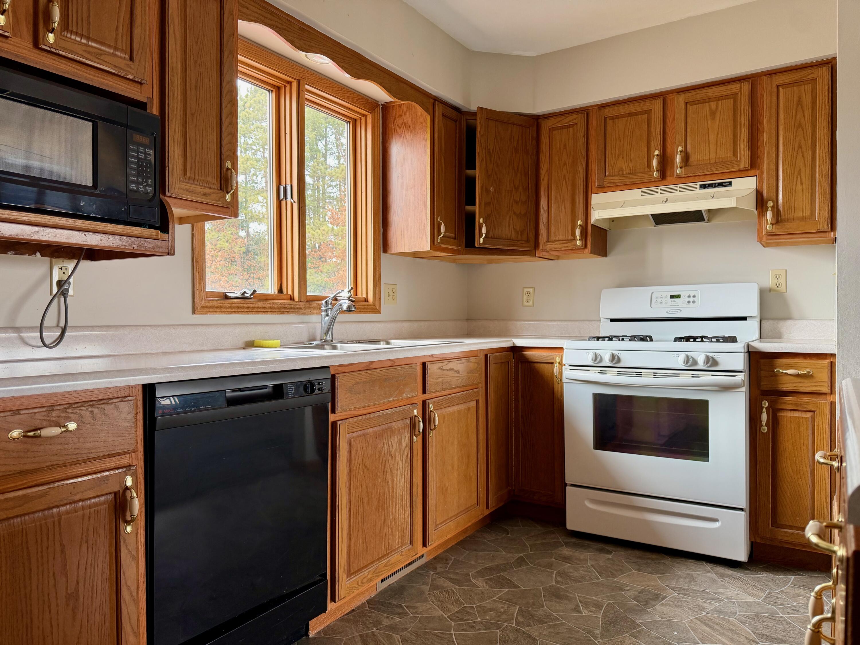 5831 West 700 North Winamac, IN 46996 - Photo 6 of 22 a kitchen with stainless steel appliances granite countertop a sink and a stove