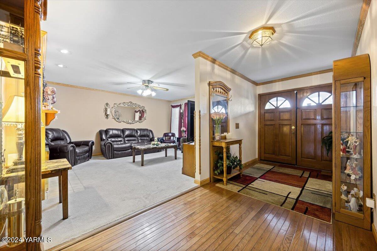 1802 Young Street Grandview, WA 98930 - Photo 12 of 31 a living room with furniture a flat screen tv and a floor to ceiling window