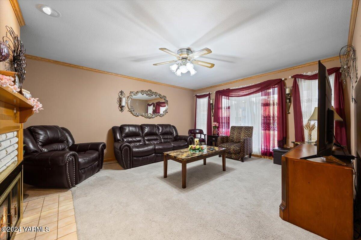 1802 Young Street Grandview, WA 98930 - Photo 13 of 31 a living room with furniture ceiling fan and a window