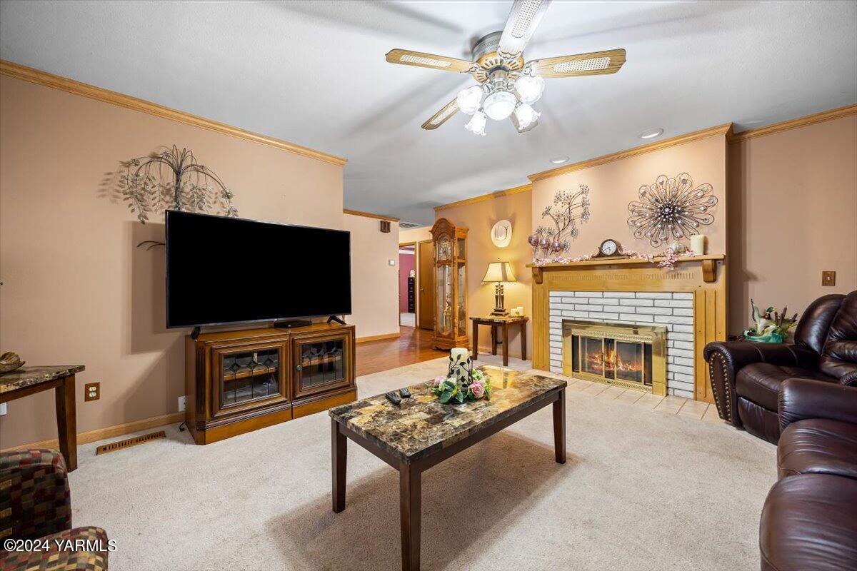 1802 Young Street Grandview, WA 98930 - Photo 14 of 31 a living room with furniture a flat screen tv and a fireplace