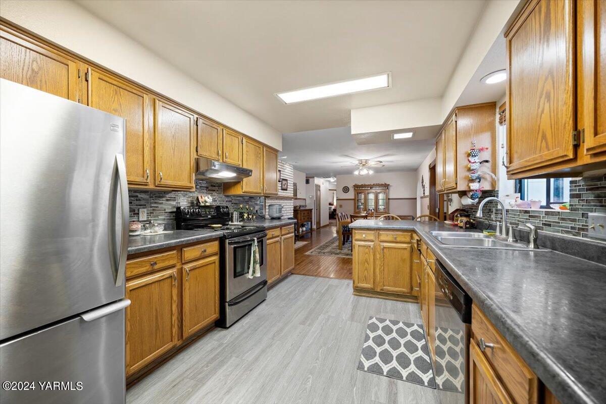 1802 Young Street Grandview, WA 98930 - Photo 21 of 31 a kitchen with stainless steel appliances granite countertop a sink a stove and refrigerator