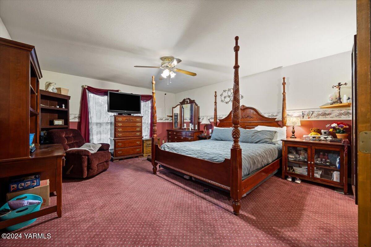 1802 Young Street Grandview, WA 98930 - Photo 29 of 31 a bedroom with a bed a flat screen tv and dresser