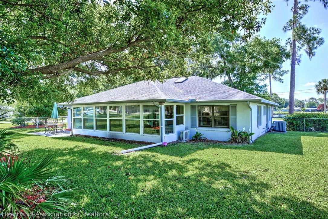 3601 Divot Road Sebring, FL 33872 - Photo 5 of 31 a view of a house with a yard and sitting area