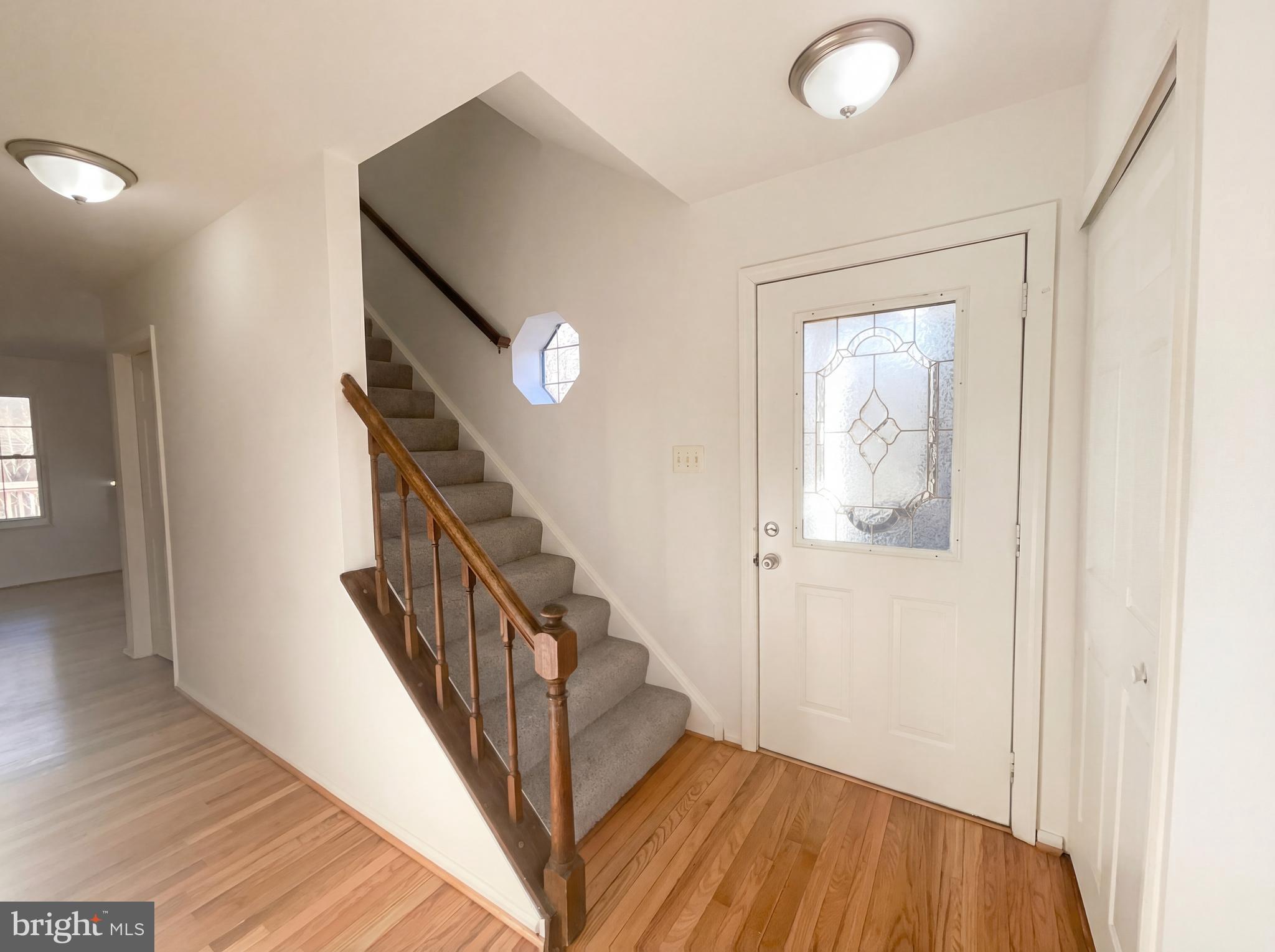 6352 Shaundale Drive Springfield, VA 22152 - Photo 14 of 50 a view of a hallway with wooden floor and stairs