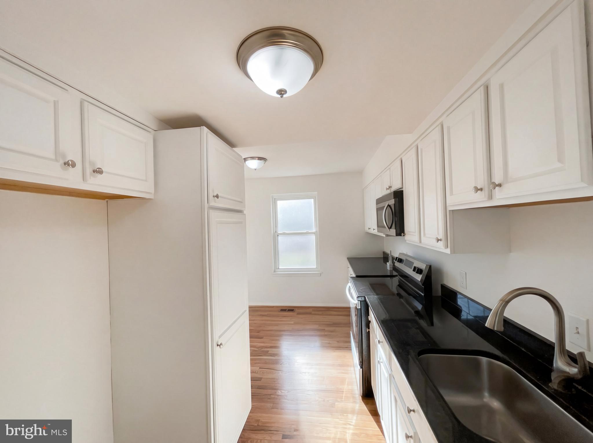 6352 Shaundale Drive Springfield, VA 22152 - Photo 15 of 50 a kitchen with granite countertop a stove a sink dishwasher and a stove with wooden floor