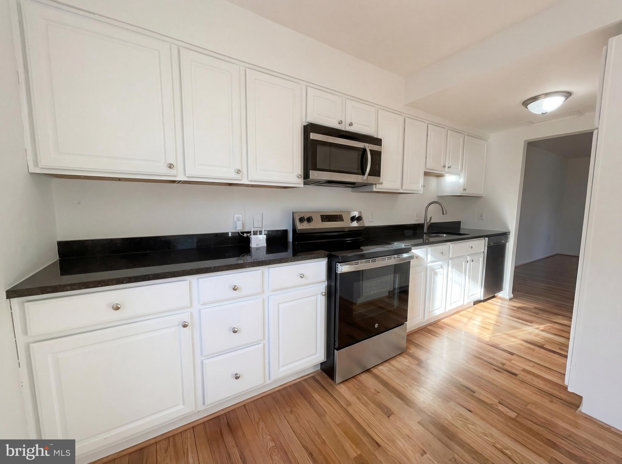 6352 Shaundale Drive Springfield, VA 22152 - Photo 3 of 50 a kitchen with white cabinets stainless steel appliances and sink