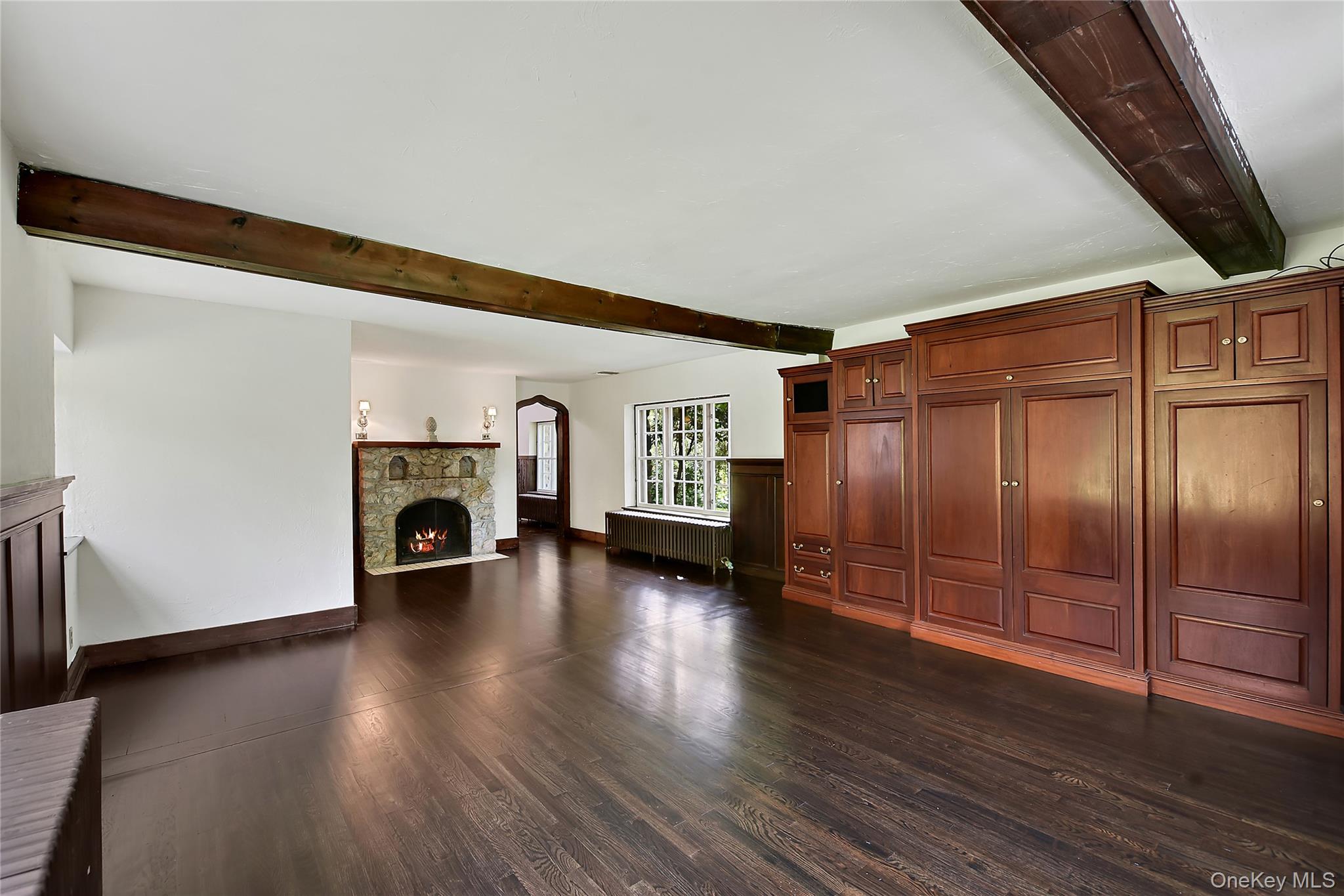 160 Long Ridge Road Bedford, NY 10506 - Photo 9 of 25 an empty room with wooden floor fireplace and windows