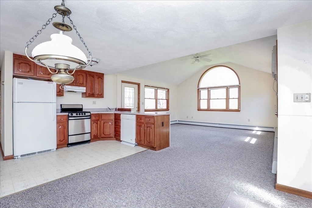 19 Longbow Road Danvers, MA 01923 - Photo 31 of 39 a kitchen with stainless steel appliances granite countertop a stove a sink and a refrigerator