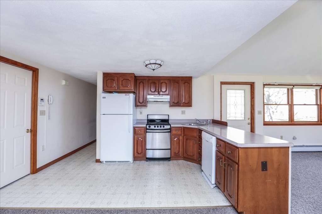 19 Longbow Road Danvers, MA 01923 - Photo 32 of 39 a kitchen with stainless steel appliances granite countertop a stove top oven a sink and dishwasher