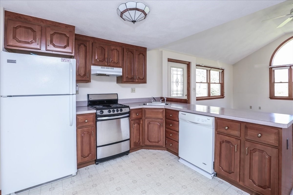 19 Longbow Road Danvers, MA 01923 - Photo 34 of 39 a kitchen with stainless steel appliances granite countertop a refrigerator a stove a sink and a more cabinets