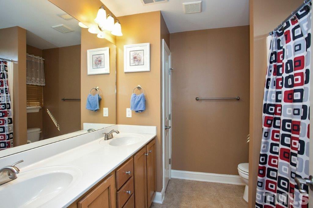 103 Orkney Road Stem, NC 27581 - Photo 14 of 25 a bathroom with a sink and a mirror