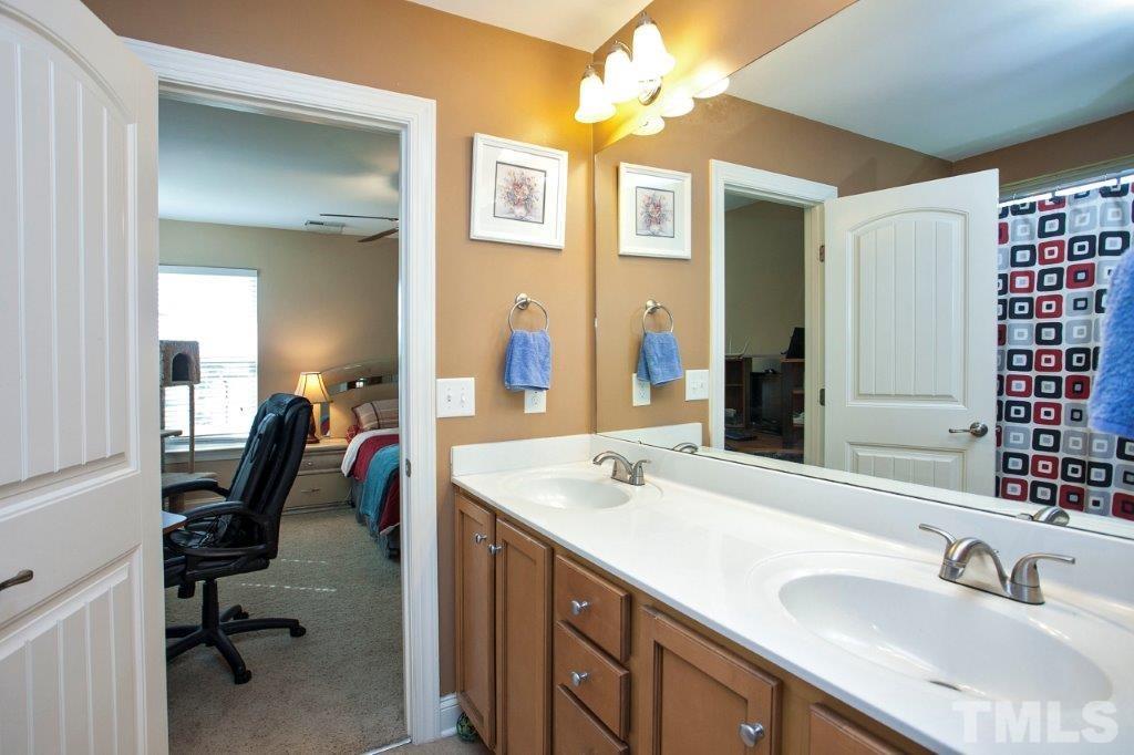 103 Orkney Road Stem, NC 27581 - Photo 15 of 25 a en suite bathroom with a sink double vanity and a mirror