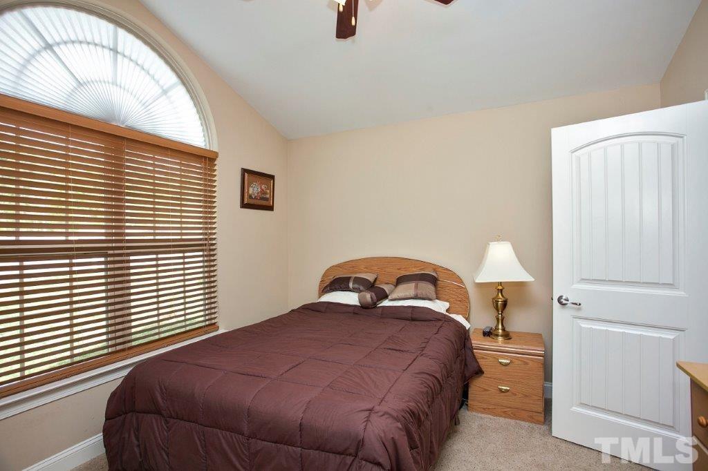 103 Orkney Road Stem, NC 27581 - Photo 18 of 25 a bedroom with a bed and a large window
