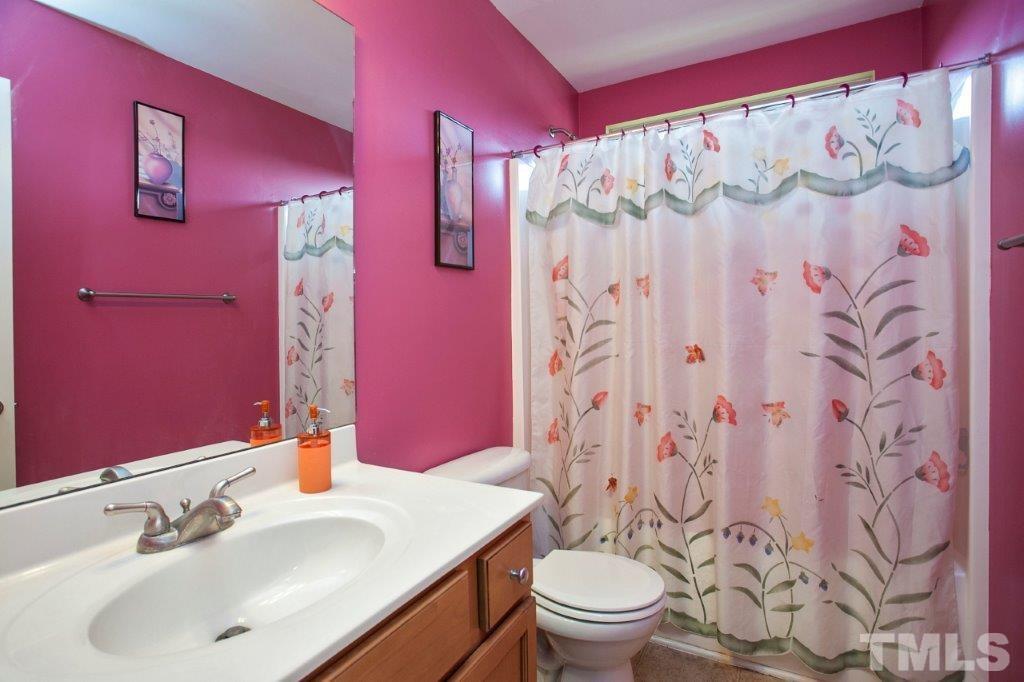 103 Orkney Road Stem, NC 27581 - Photo 20 of 25 a bathroom with a sink and mirror with toilet