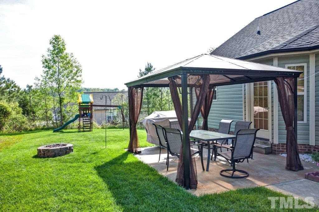 103 Orkney Road Stem, NC 27581 - Photo 22 of 25 a view of a backyard with table and chairs and a yard