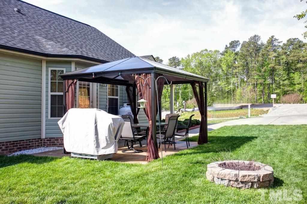 103 Orkney Road Stem, NC 27581 - Photo 23 of 25 a view of a chair and table in backyard of the house