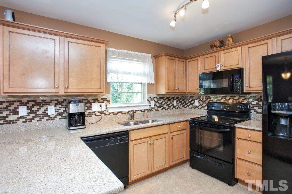103 Orkney Road Stem, NC 27581 - Photo 5 of 25 a kitchen with a sink stove and microwave