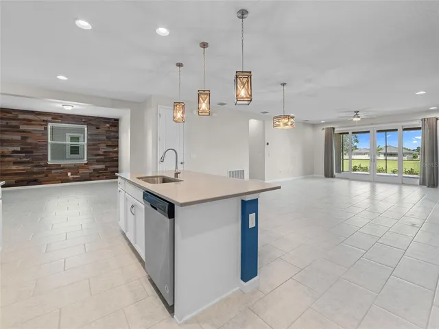 a kitchen with granite countertop a sink and a stove top oven