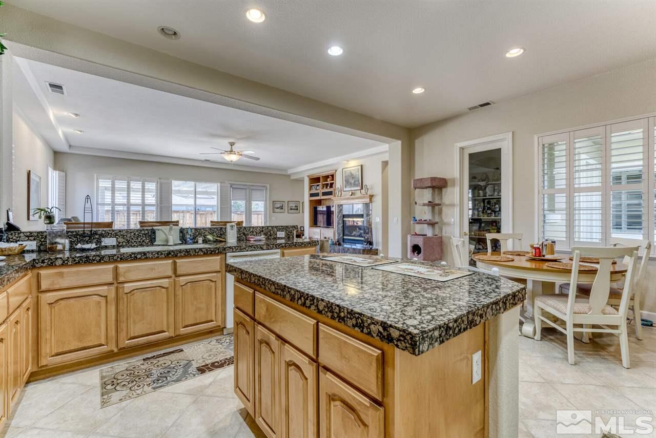 10040 Burghley Lane Reno, NV 89521 - Photo 21 of 39 a kitchen with center island table and chairs